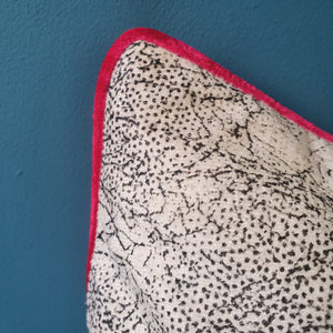 Abstract animal print velvet cushion with shocking pink velvet piping